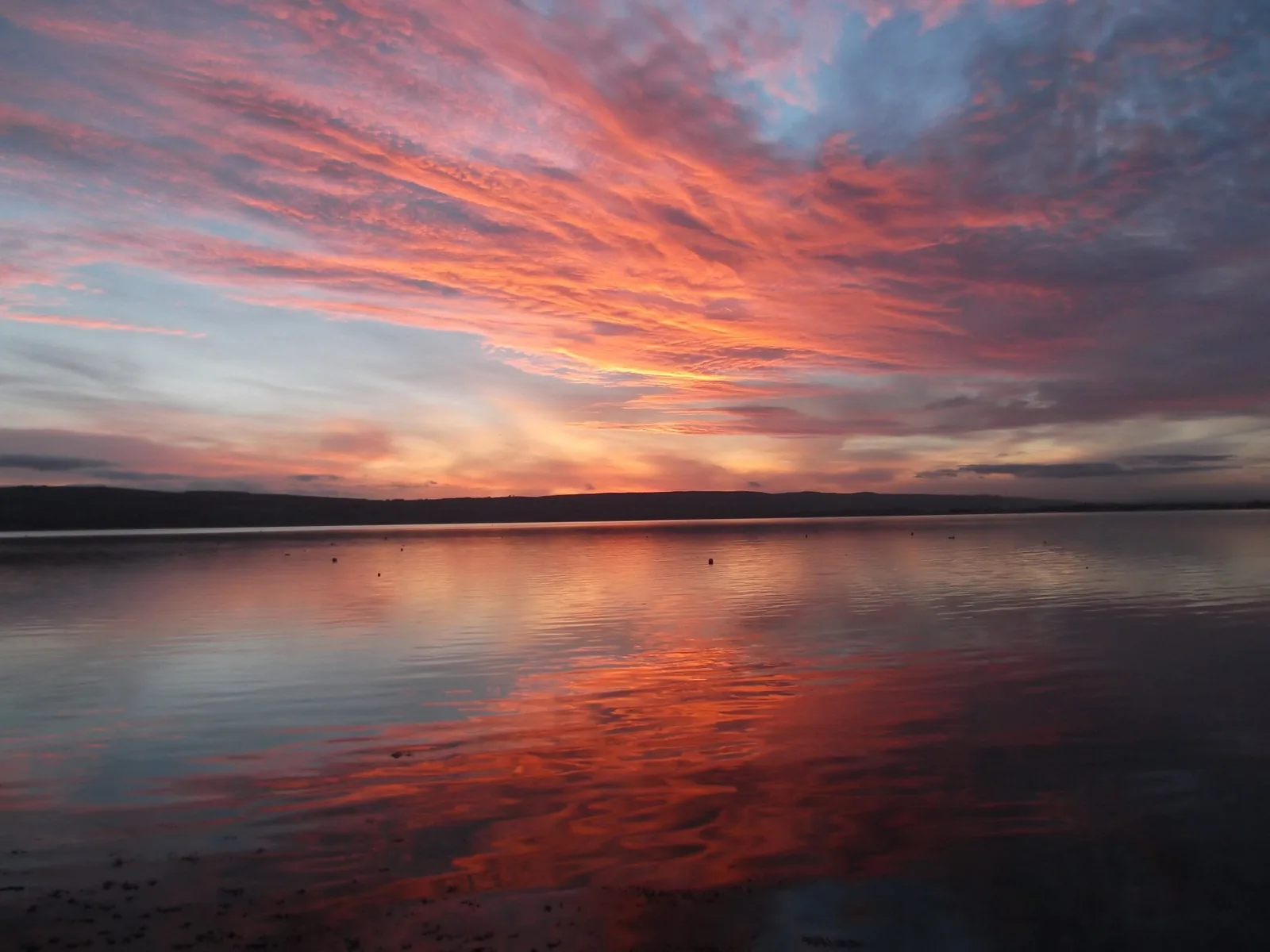 Sunset reflected in still water at dusk